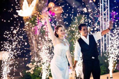 Bride and groom waving hands