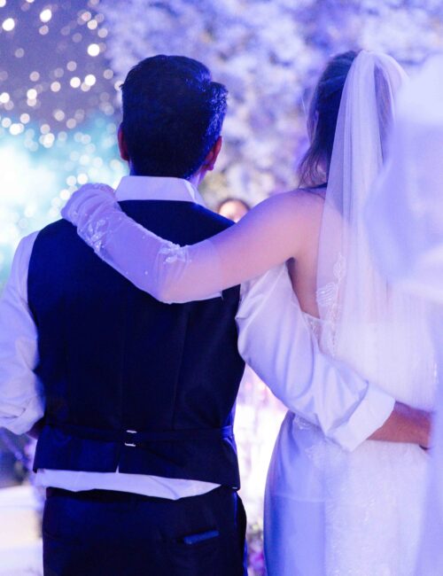 Groom hugging bride